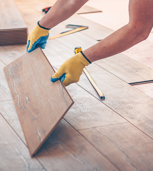 Team member installing wood flooring