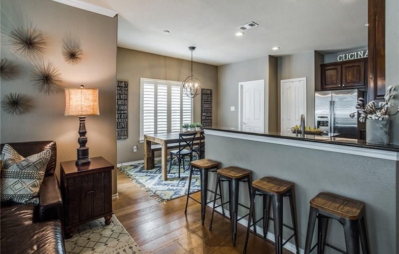 Newly installed flooring in open floor plan living dining kitchen