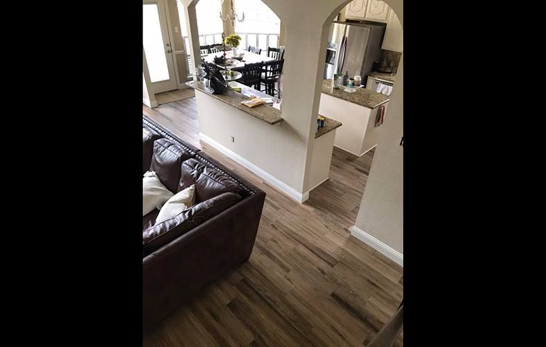 Newly installed flooring through open floor plan home