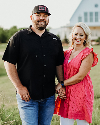 Benson and Ashley Kelly holding hands outdoor