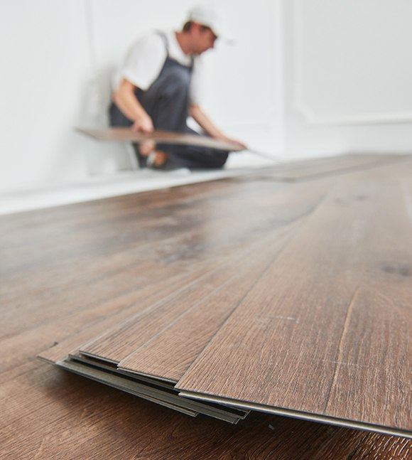 Man installing laminate flooring