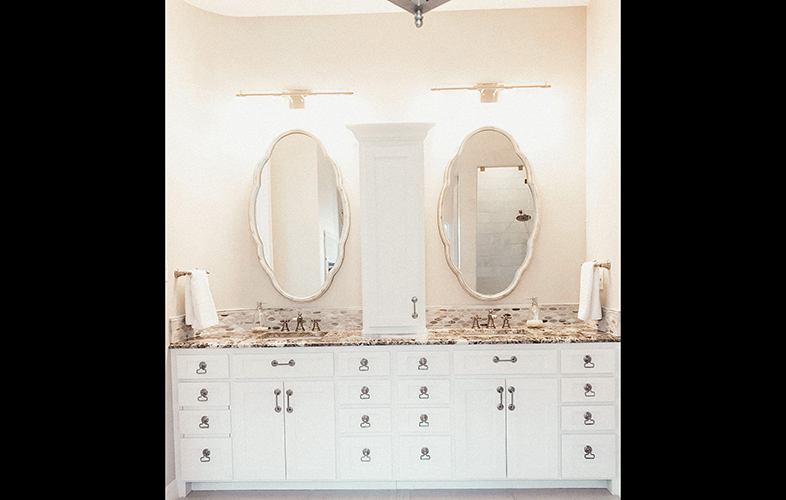 Rose colored double vanity and mirrors in remodeled bathroom