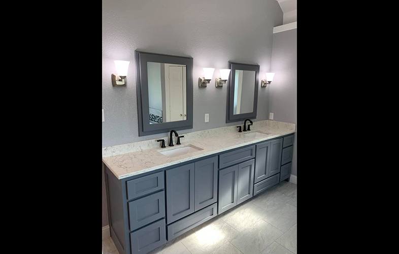 Blue tone double vanity and mirrors in newly remodeled bathroom