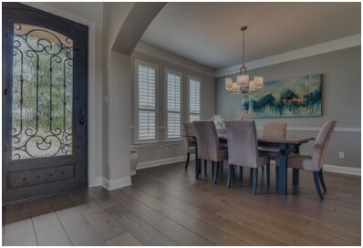 Entryway and dining room with wood flooring