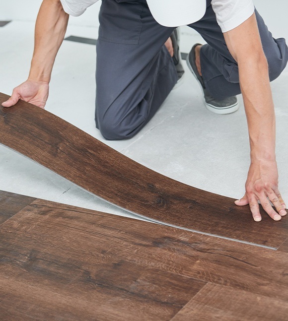 Person installing vinyl flooring