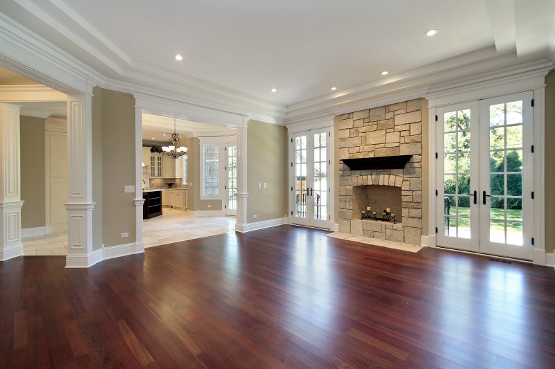 a large open living room with wood flooring