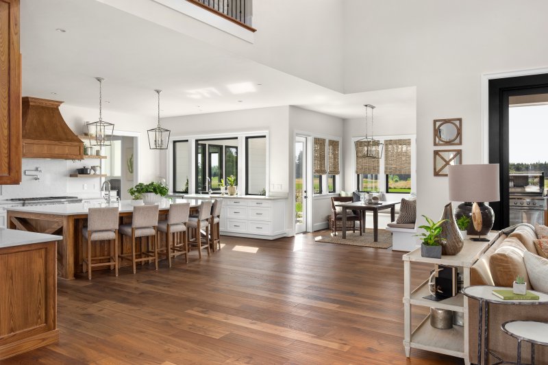 hardwood floors located in an open area space between the kitchen and living room