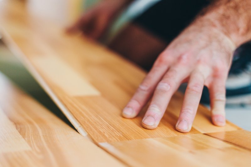 a professional installing floating flooring in Keller