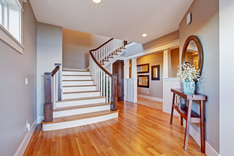 an entryway with light hardwood floors