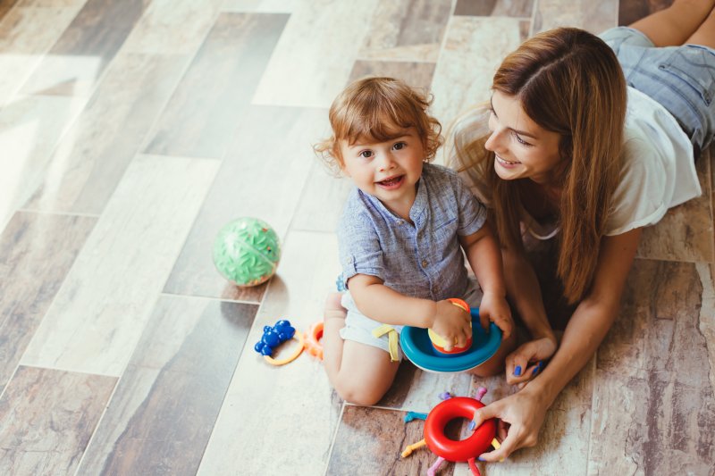 mom playing with son on the floor