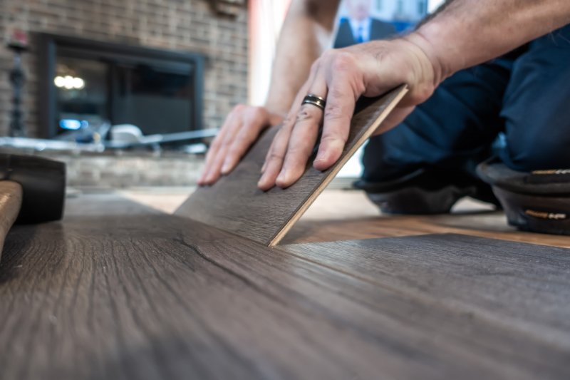 Person laying engineered wood floors