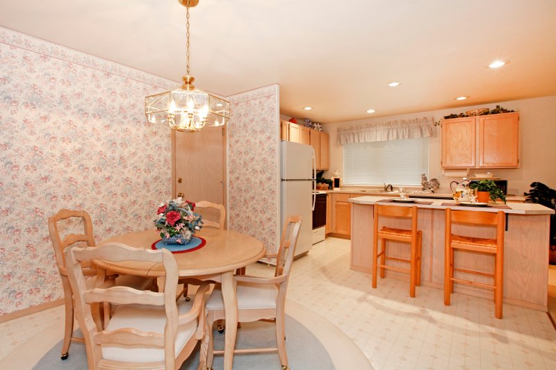 an outdated kitchen and dining area